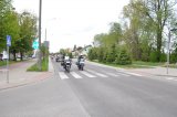 Policjant na motocyklu dba o bezpieczny przejazd kolumny motocykli.