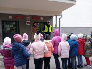 Dzieci stoja przed szkołą.