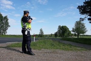 Policjant w mundurze stoi na świeżym powietrzu.