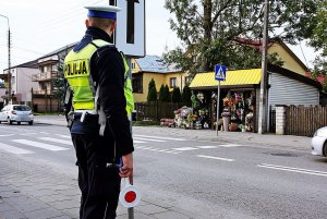Policjant w mundurze stoi przy ulicy.