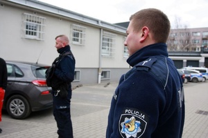 Osoby stoja na placu.