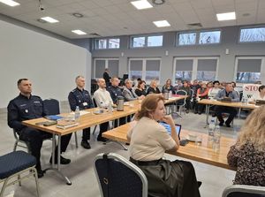 Policjanci rozmawiają z mieszkańcami podczas debaty społecznej.