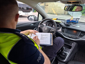 Policjant kontroluje autobus.